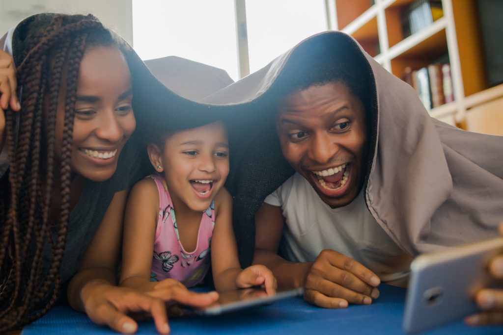 Family taking a selfie with phone.